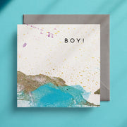 Turquoise, gold and white greeting card design with the caption "Boy!"