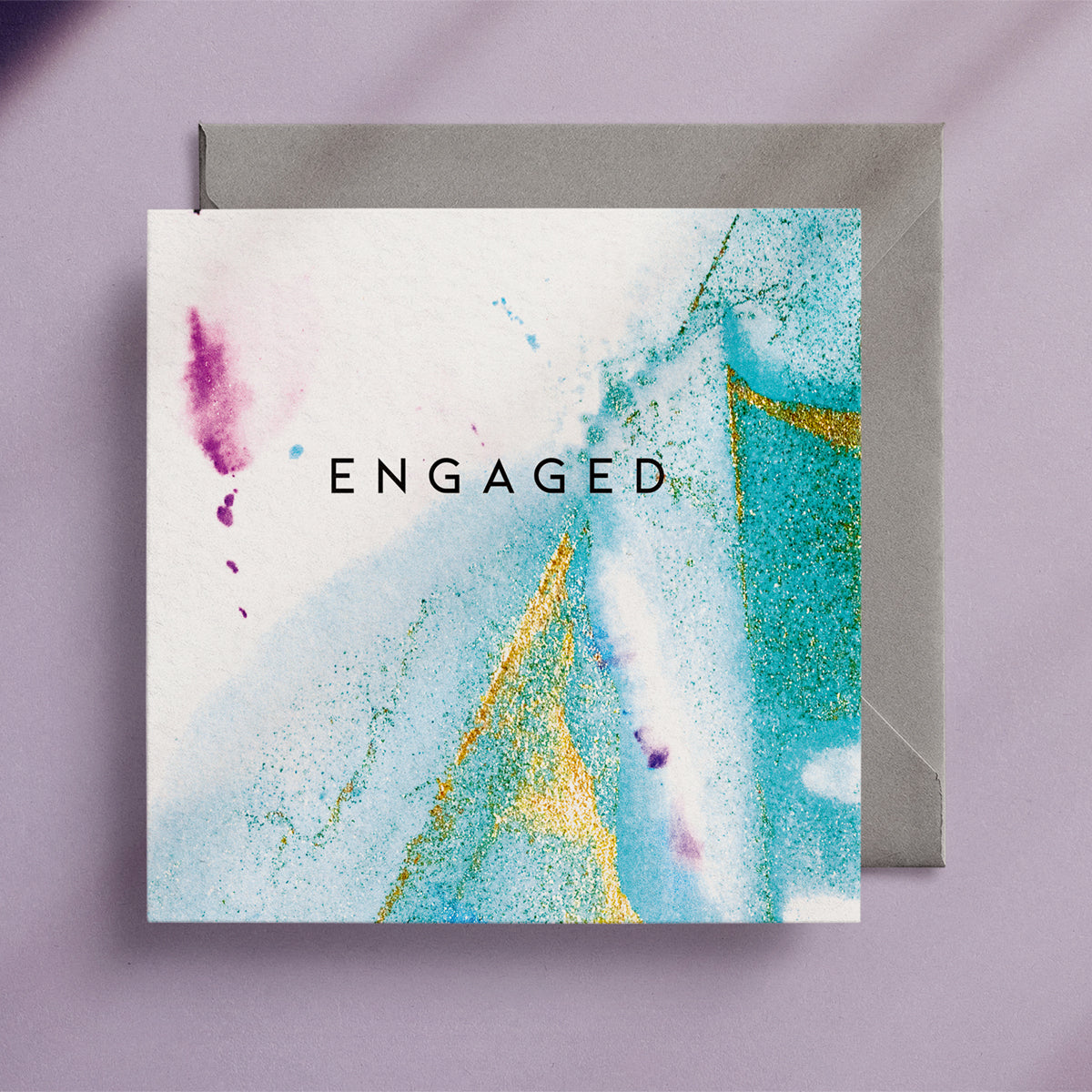 "Engaged" square greeting card with a turquoise and gold alcohol ink design and a grey envelope