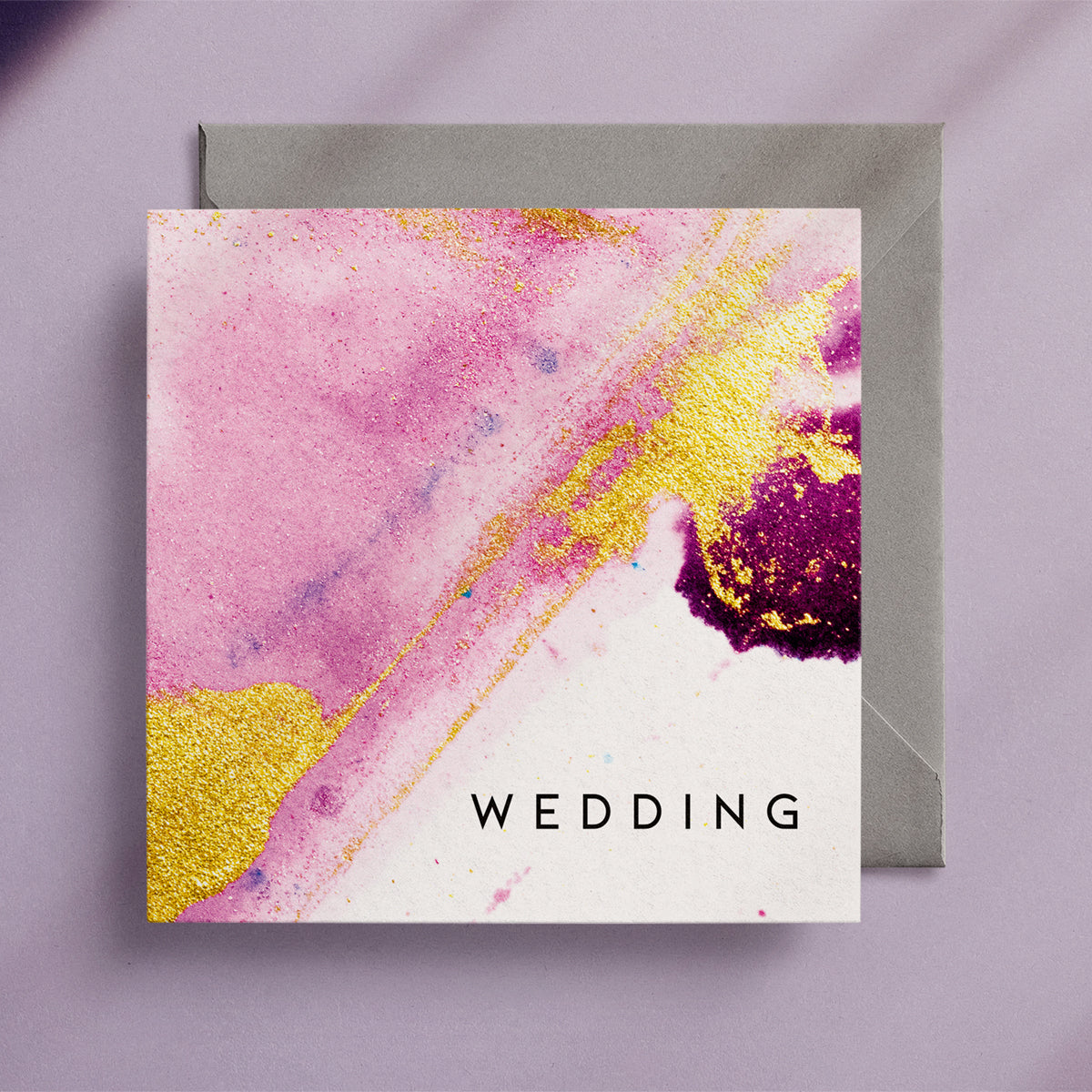 Pretty, pink and gold abstract wedding card on a lilac background