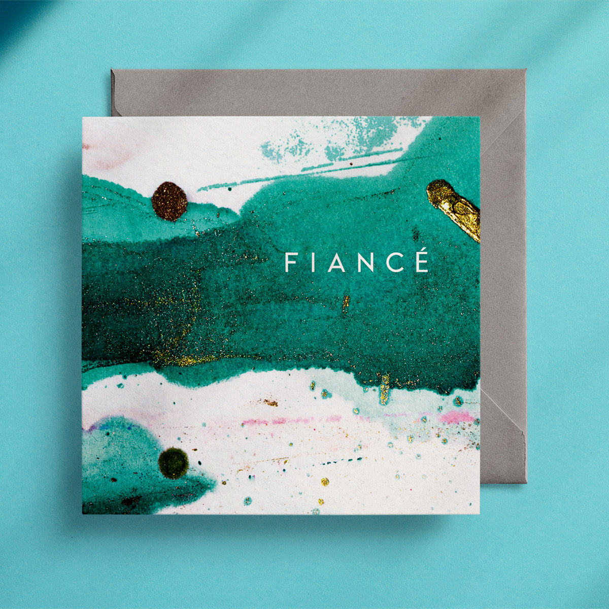 Rich emerald green and splashes of gold on a square greeting card with the caption "Fiancé"
