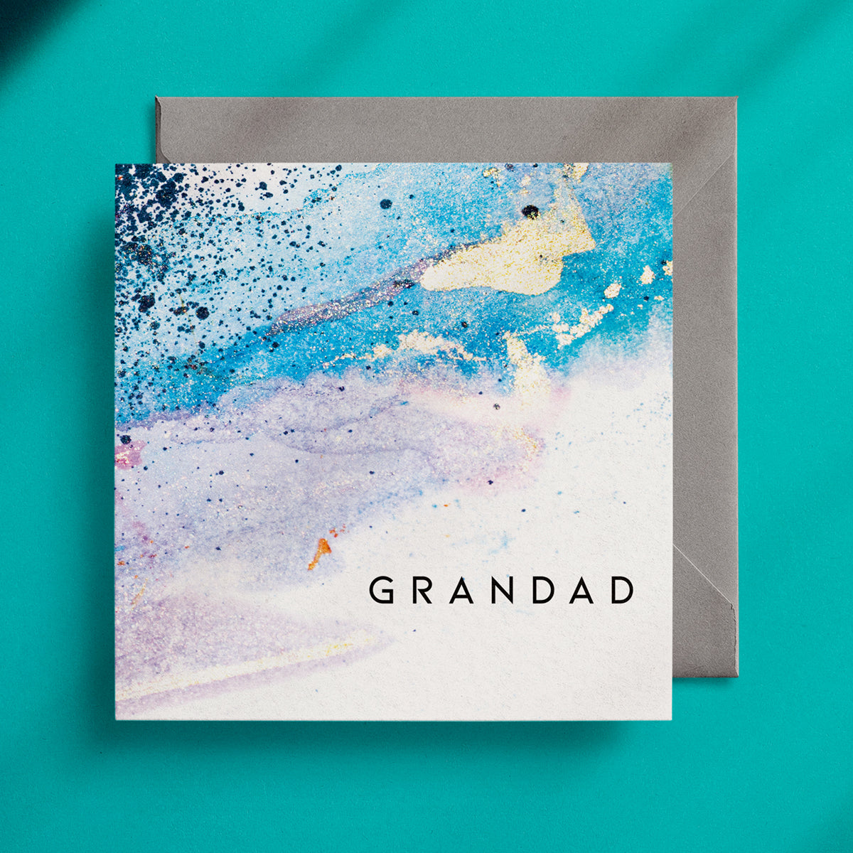 Light blue, abstract design on a square greeting card with the caption "Grandad"