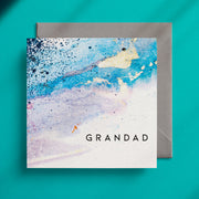 Light blue, abstract design on a square greeting card with the caption "Grandad"