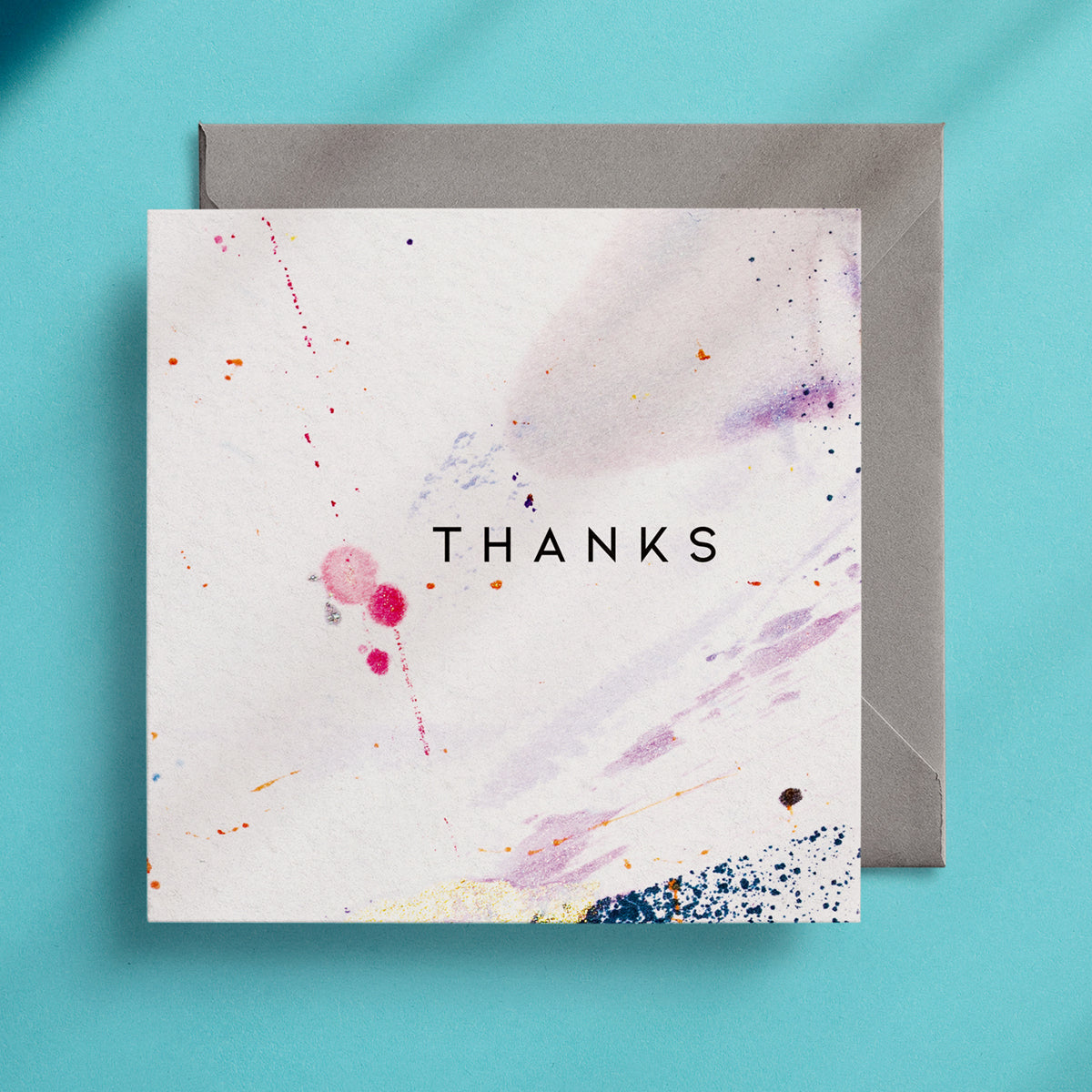 Square greeting card with the word "Thanks" in the centre with a minimalist, abstract design